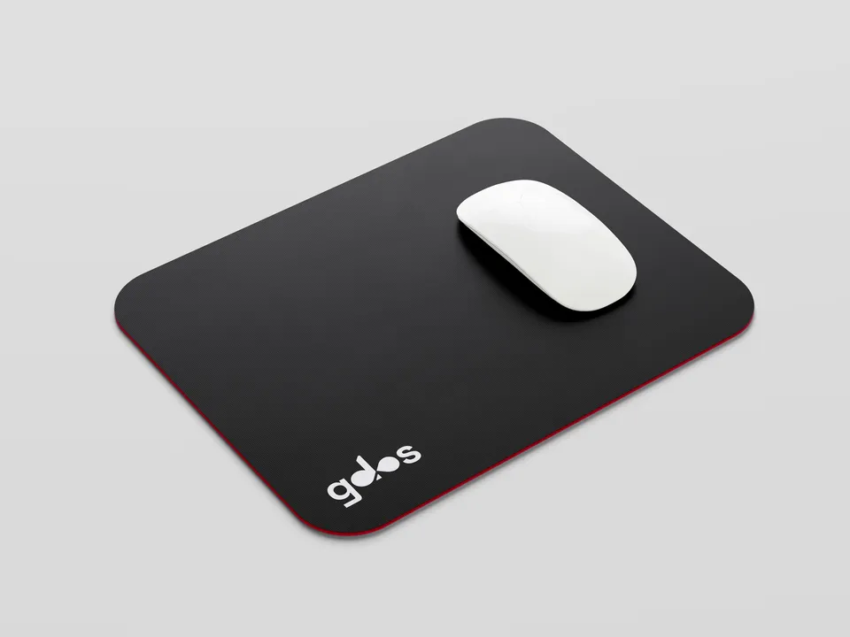 Black mousepad with a red edge and a small gdos logo, with a white mouse on top.